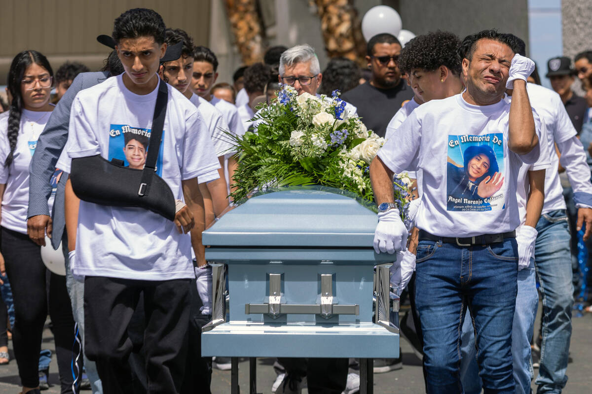 Rudolfo Naranjo, right, is overcome with emotions as he and son Arley with others wheel the cas ...