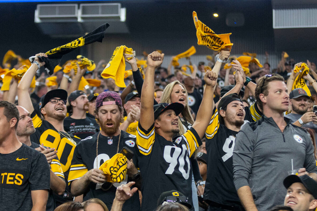 Pittsburgh Steelers fans wave their towels and celebrate after a touchdown is scored by wide re ...