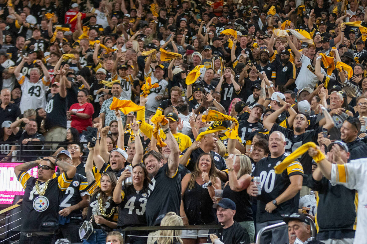 Pittsburgh Steelers fans wave their towels during the first half an NFL game against the Raider ...
