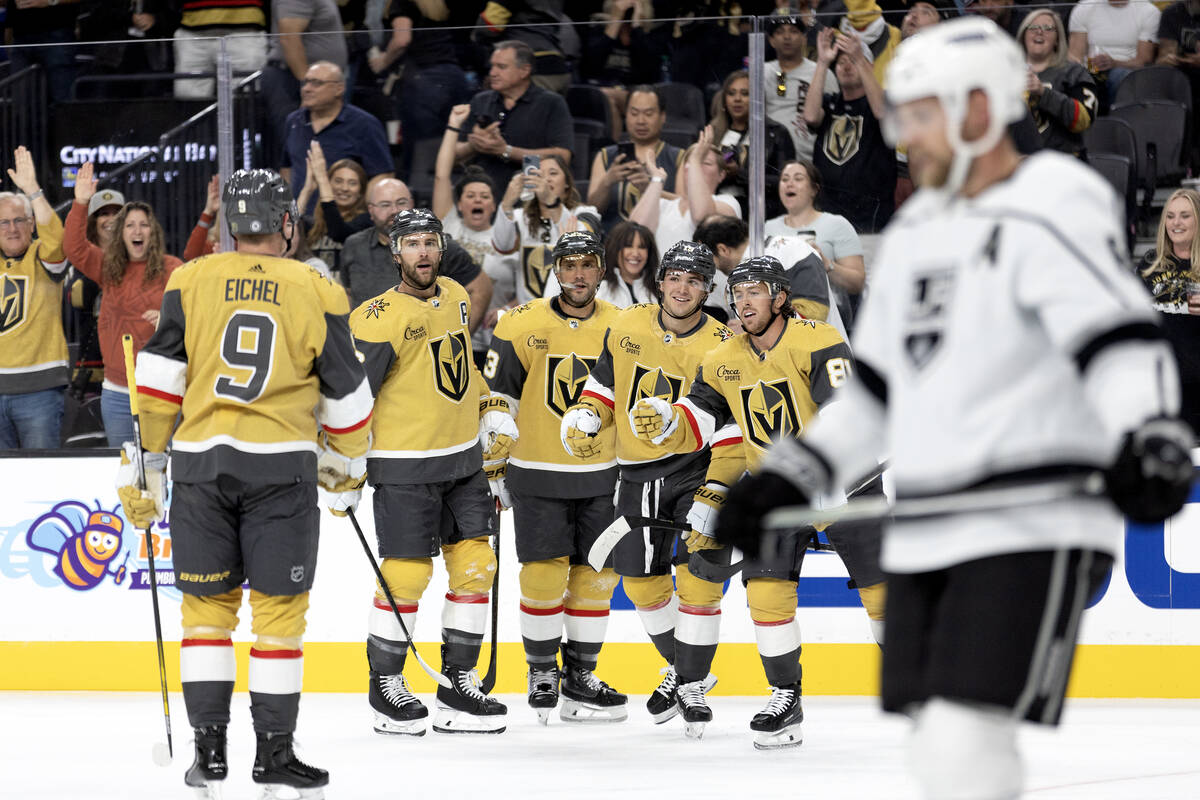 The Golden Knights celebrate a goal shot by center Brendan Brisson (19), third from right, duri ...