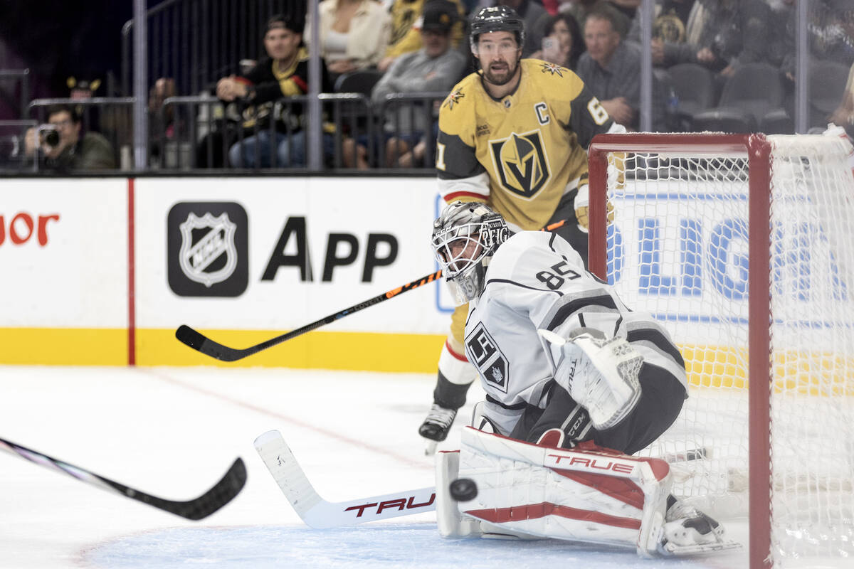 Kings goaltender Jean-Francois Berube (85) reaches to save while a shot by Golden Knights right ...