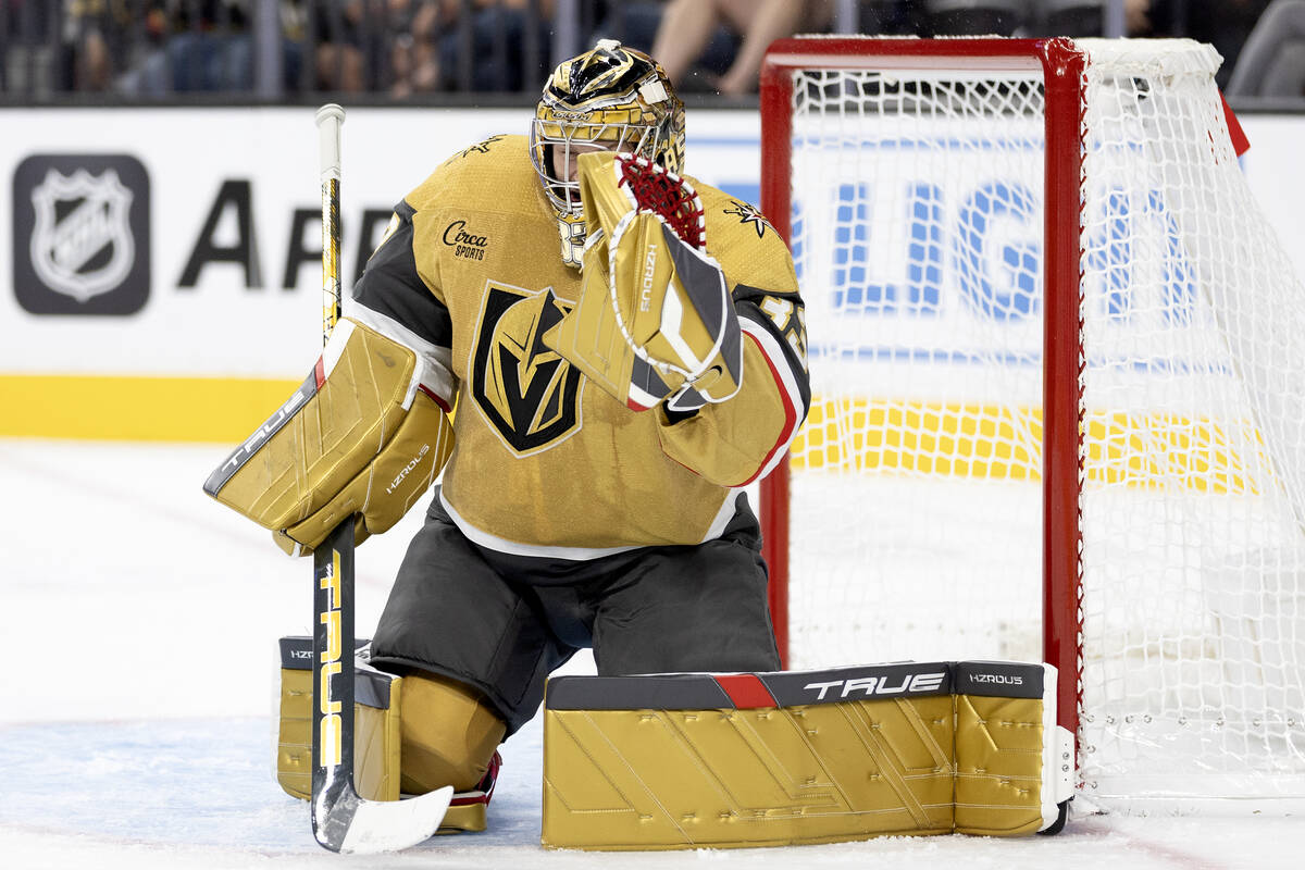 Golden Knights goaltender Adin Hill (33) makes a glove save during the second period of an NHL ...