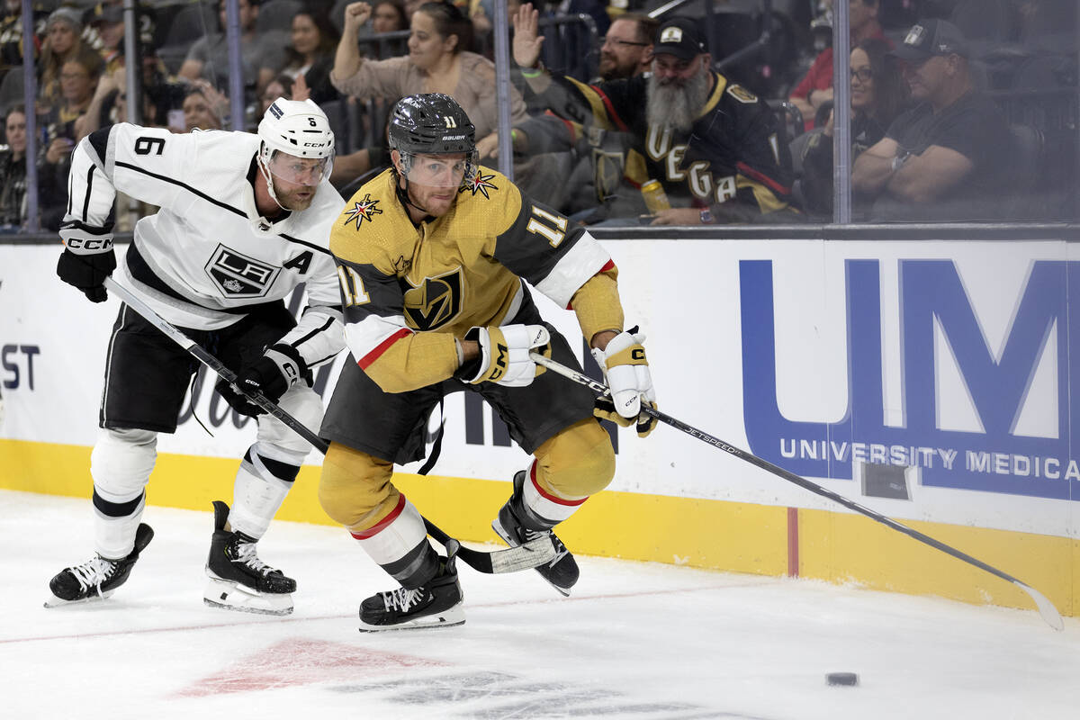 Golden Knights forward Mason Morelli (11) skates for the puck followed by Kings defenseman Kevi ...