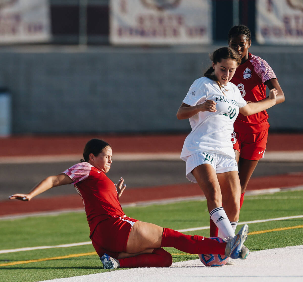 Palo Verde forward Arden Petkewich (20) tries to kick the ball away from Coronado players durin ...