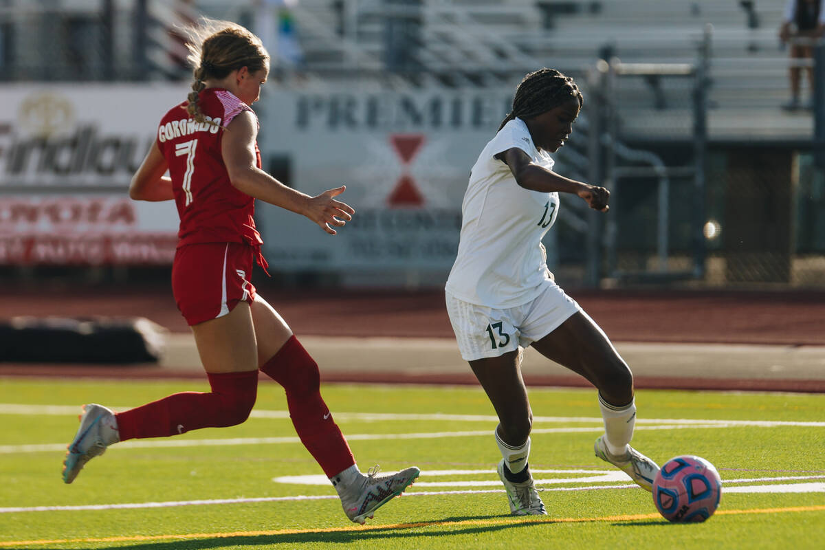 Palo Verde forward India Wilson (13) kicks the ball as Coronado defensive player Kerrigyn Lynam ...