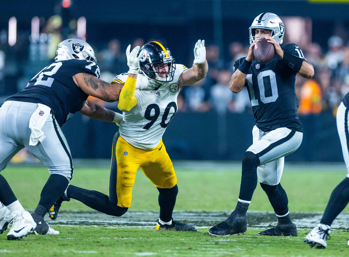 Raiders quarterback Jimmy Garoppolo (10) looks to avoid after another sack by Pittsburgh Steele ...