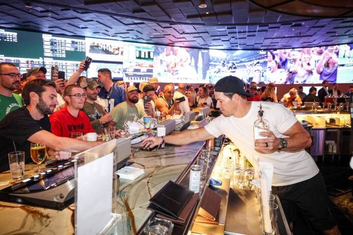 Actor Mark Wahlberg pours some drinks at the grand opening of Yahoo Sportsbook at The Venetian ...