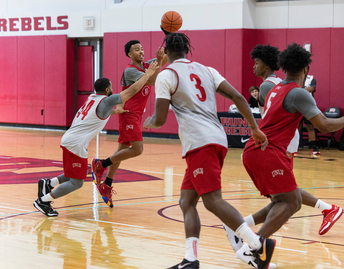 UNLV Rebels point guard Dedan Thomas Jr., second left, (11) passes the ball during team practi ...