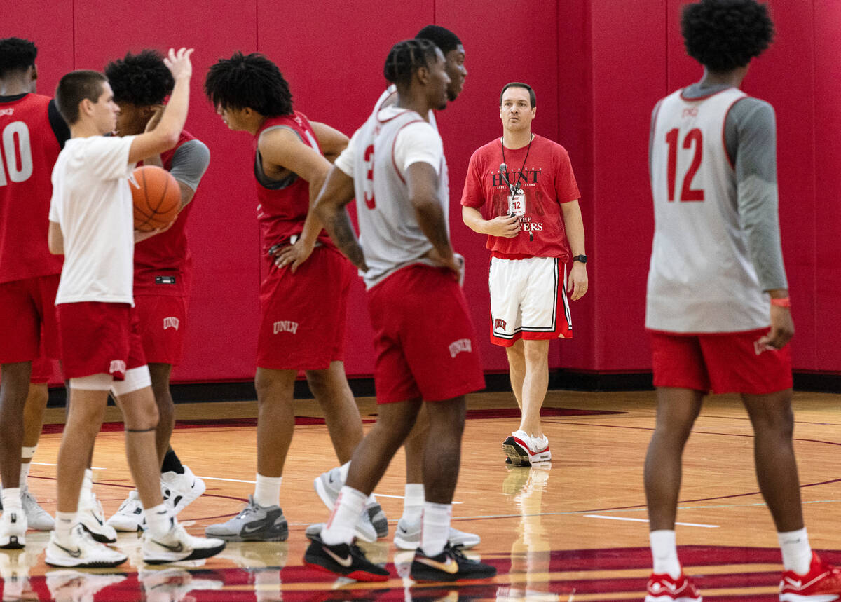 UNLV's men's basketball head coach Kevin Kruger, second right, watches his players practice, on ...