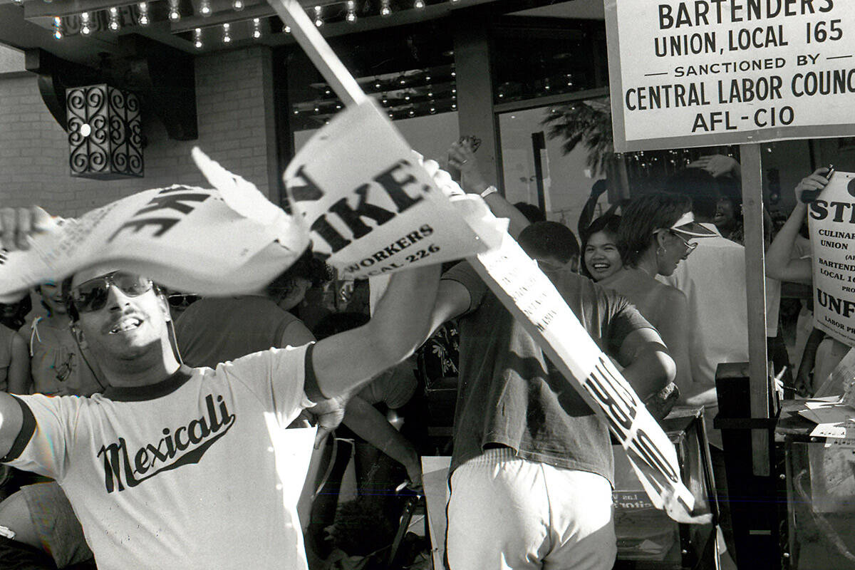 Tadeo Martinez tears up his picket sign in front of the El Cortez when strikers received word t ...