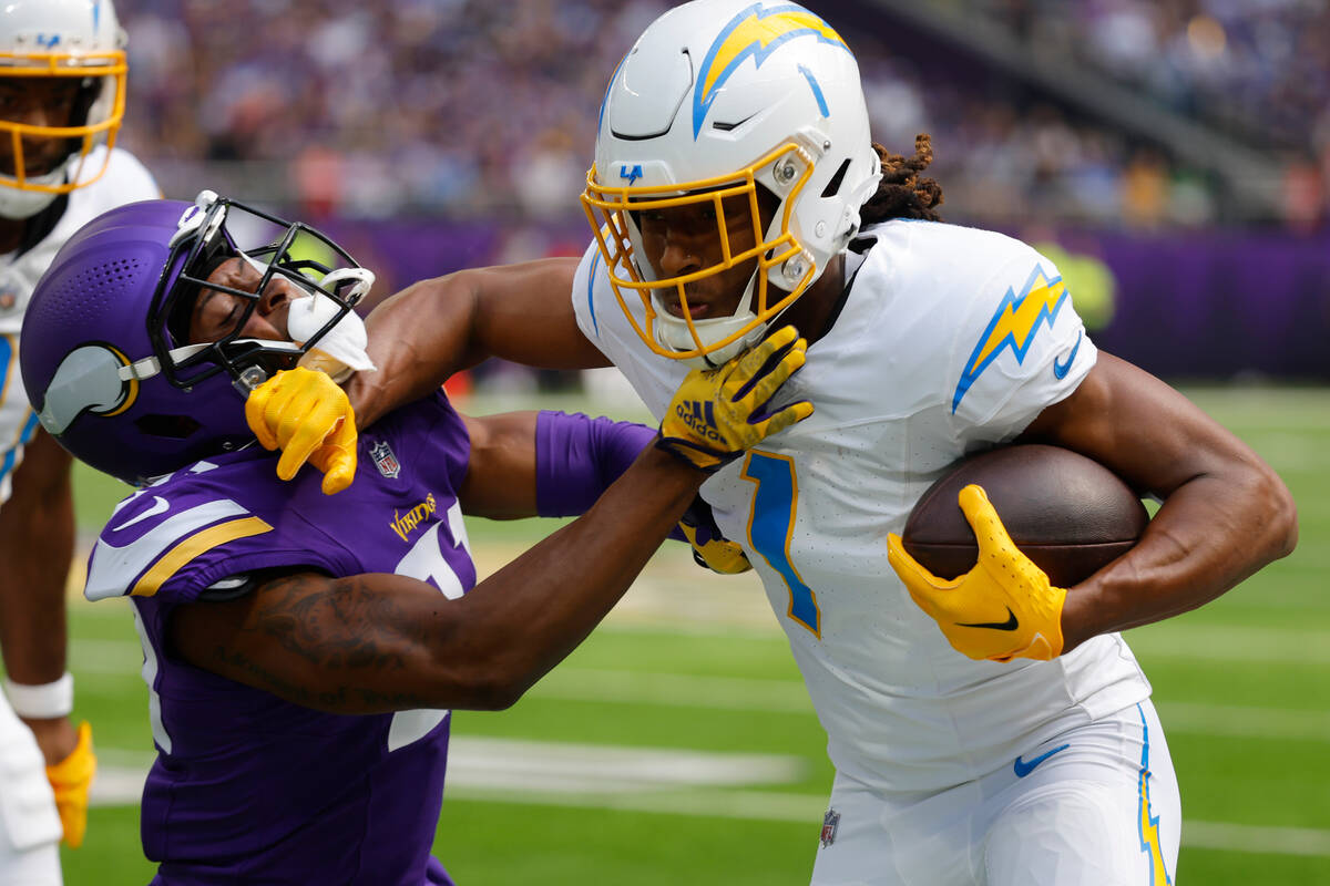 Los Angeles Chargers wide receiver Quentin Johnston (1) is tackled by Minnesota Vikings cornerb ...
