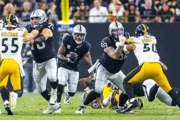 Raiders running back Josh Jacobs (8) looks to break through the line against the Pittsburgh Ste ...