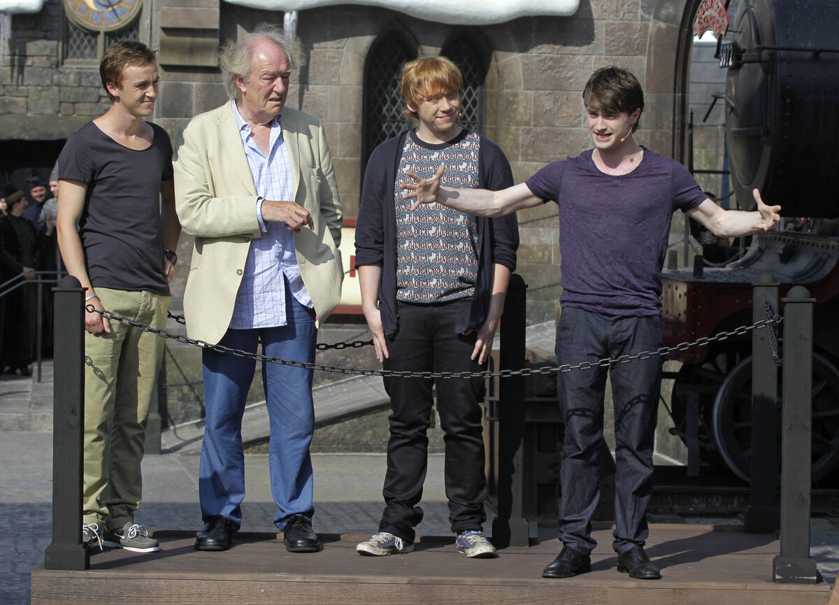 FILE - Members of the cast of the Harry Potter films, from left, Tom Felton, Michael Gambon, Ru ...