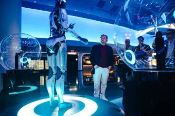 Jim Dolan, CEO of Sphere Entertainment Co., interacts with Aura, one of five humanoid robots du ...