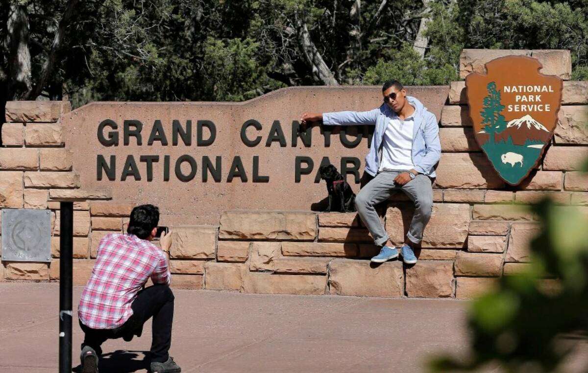Ahmed Alaawaj, of Libya, gets his photo taken by Juan Riaz, of Colombia, at the Grand Canyon Na ...