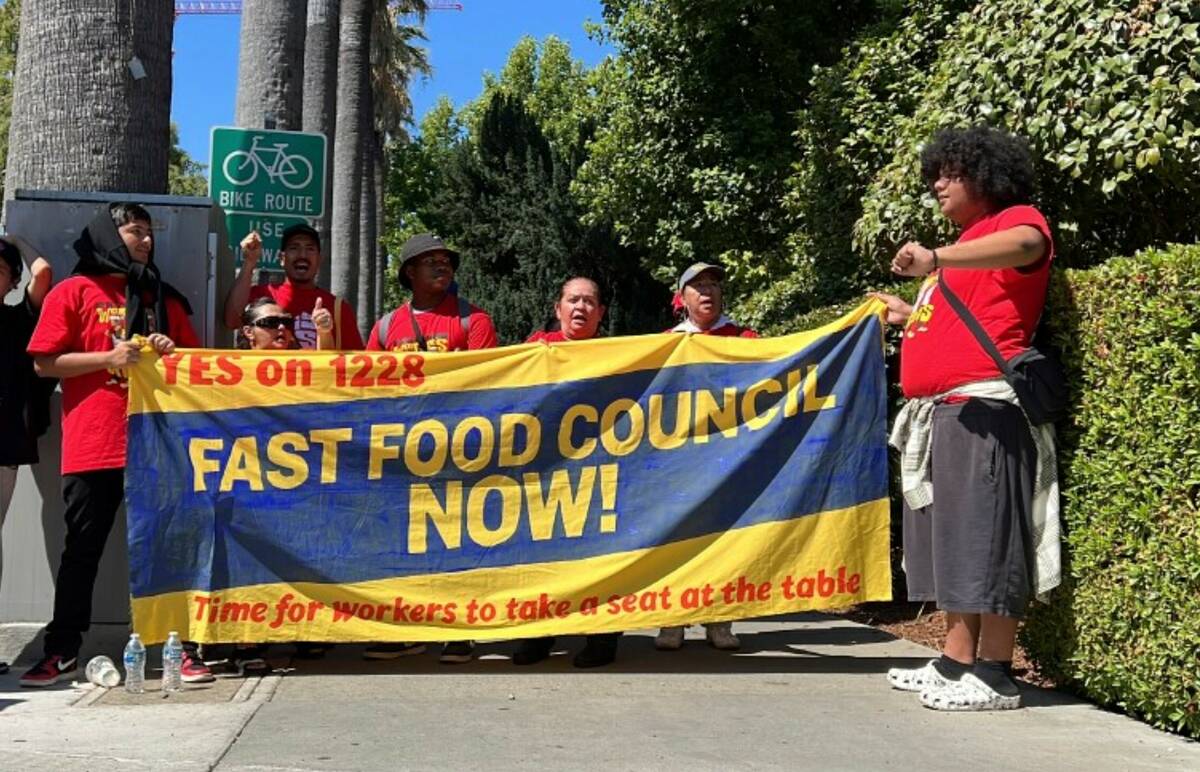 Fast food workers and union activists demonstrate outside the California State Capitol to rally ...