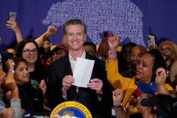 California Gov. Gavin Newsom signs the fast food bill surrounded buy fast food workers at the S ...