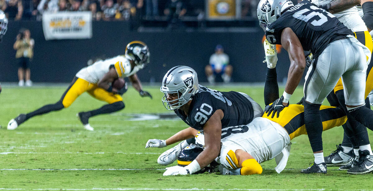 Raiders defensive tackle Jerry Tillery (90) drives Pittsburgh Steelers quarterback Kenny Picket ...