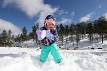 Ava Parker, 2, of Las Vegas plays in freshly fallen snow in Upper Lee Meadows on Mount Charlest ...