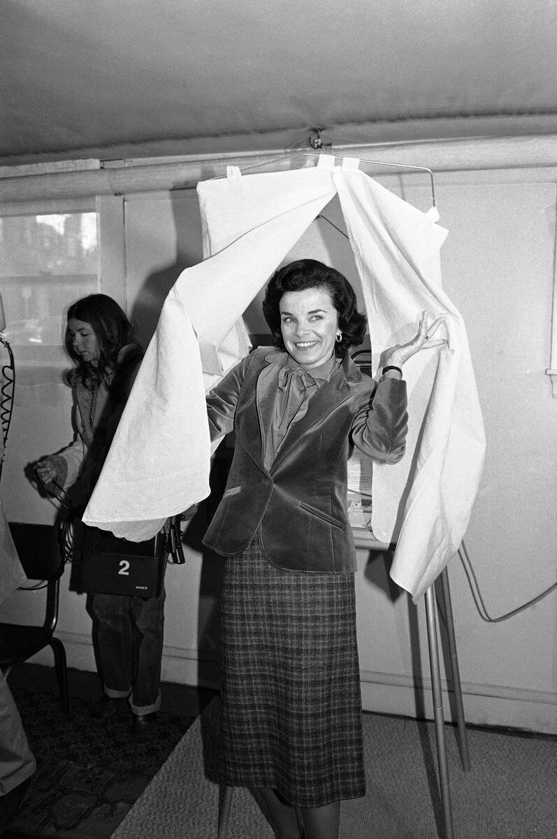 Mayor Dianne Feinstein leaves the voting booth in San Francisco, Dec. 11, 1979, after casting h ...
