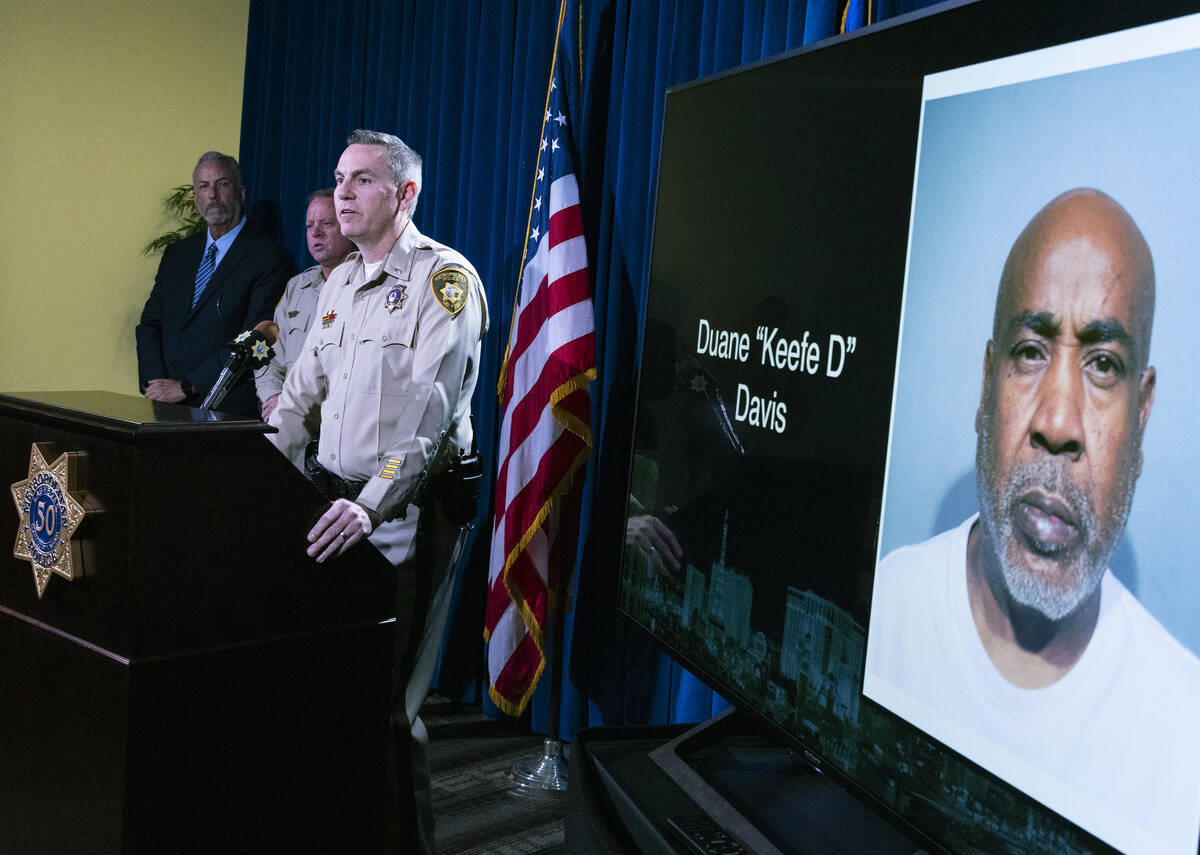 Duane "Keefe D" Davis' photograph, right, is displayed during a press conference as M ...