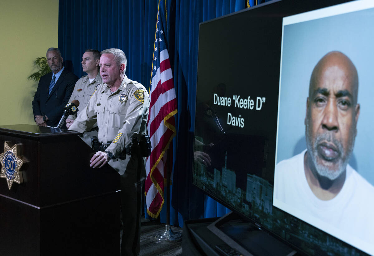 A photograph of Duane "Keefe D" Davis, right, is displayed during a press conference ...