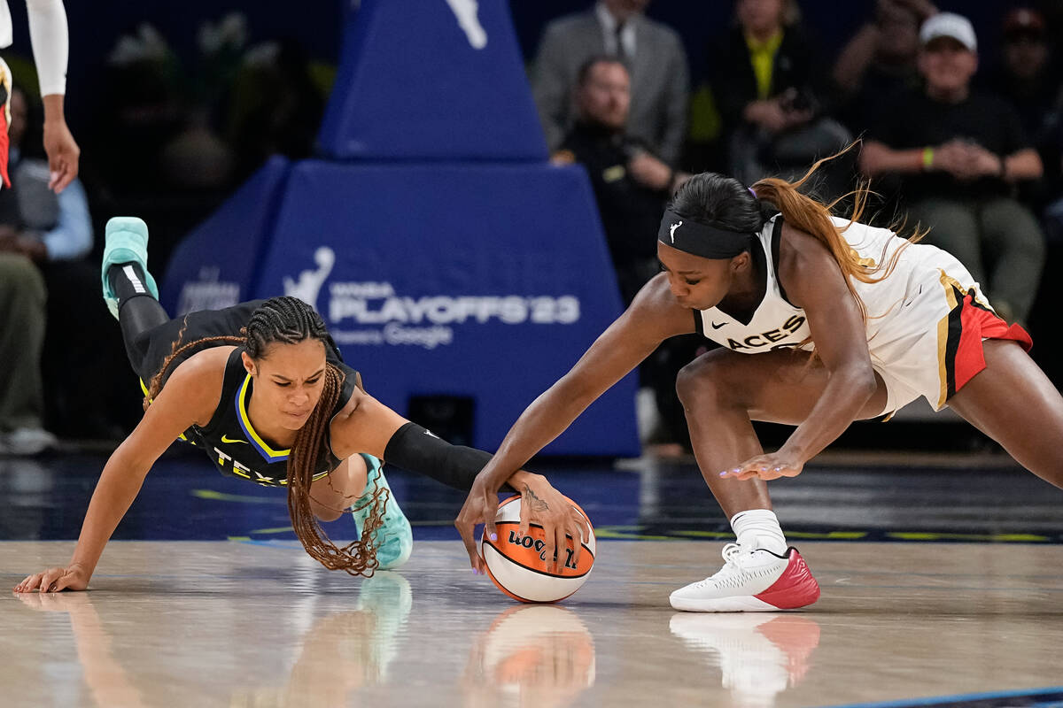 Dallas Wings forward Satou Sabally, left, and Las Vegas Aces guard Jackie Young scramble for th ...