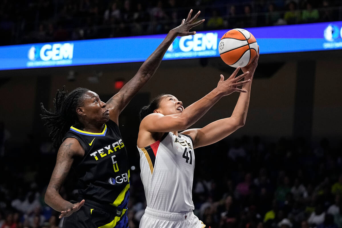 Las Vegas Aces center Kiah Stokes (41) goes to the basket as Dallas Wings forward Natasha Howar ...