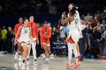 Las Vegas Aces guard Chelsea Gray (12) celebrates with guard Kierstan Bell, behind, after the t ...