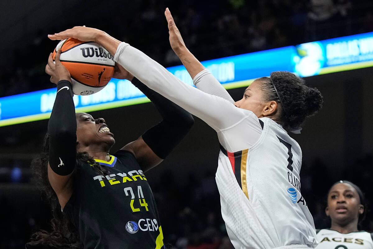 Las Vegas Aces forward Alysha Clark (7) blocks a shot by Dallas Wings guard Arike Ogunbowale (2 ...