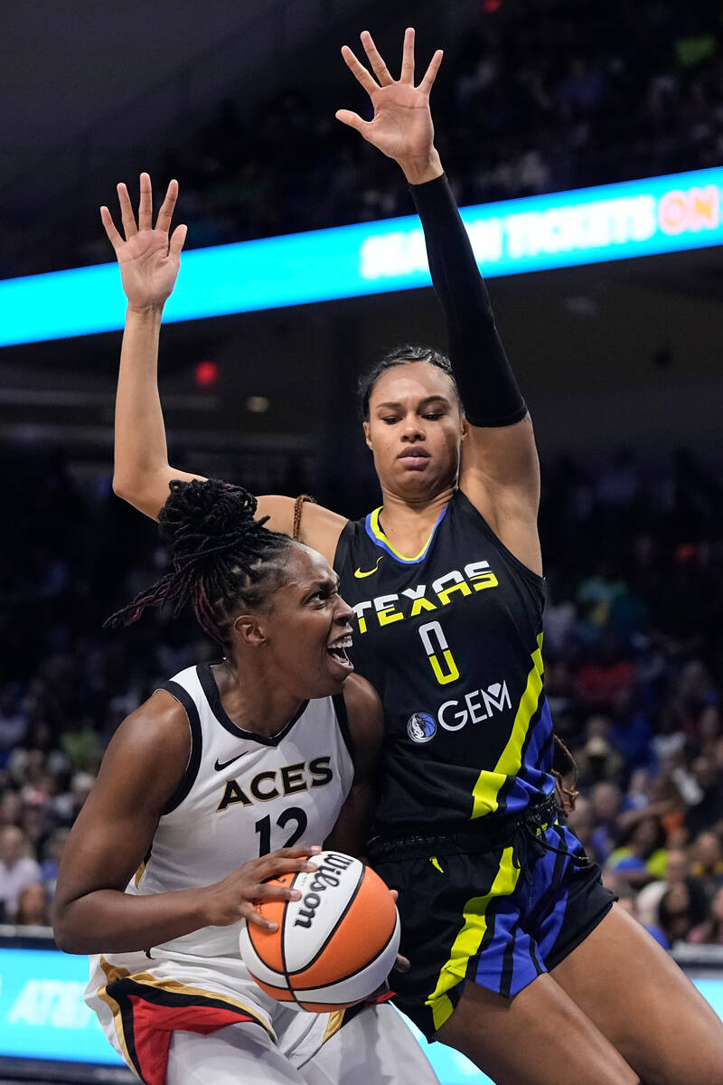 Las Vegas Aces guard Chelsea Gray (12) looks for a shot as Dallas Wings forward Satou Sabally ( ...