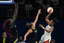 Las Vegas Aces guard Chelsea Gray (12) attempts to pass the ball past Dallas Wings guard Veroni ...