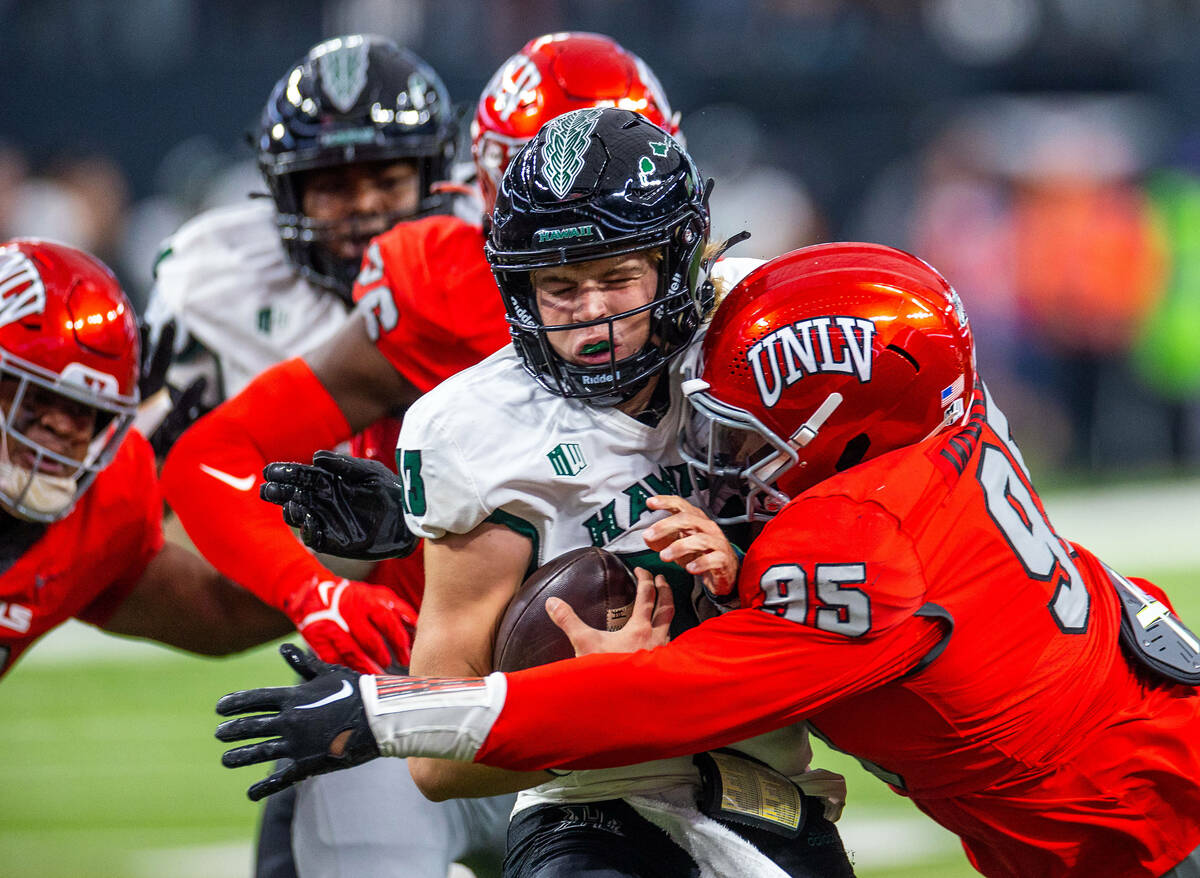 UNLV defensive lineman Alexander Whitmore (95) sacks Hawaii quarterback Brayden Schager (13) du ...