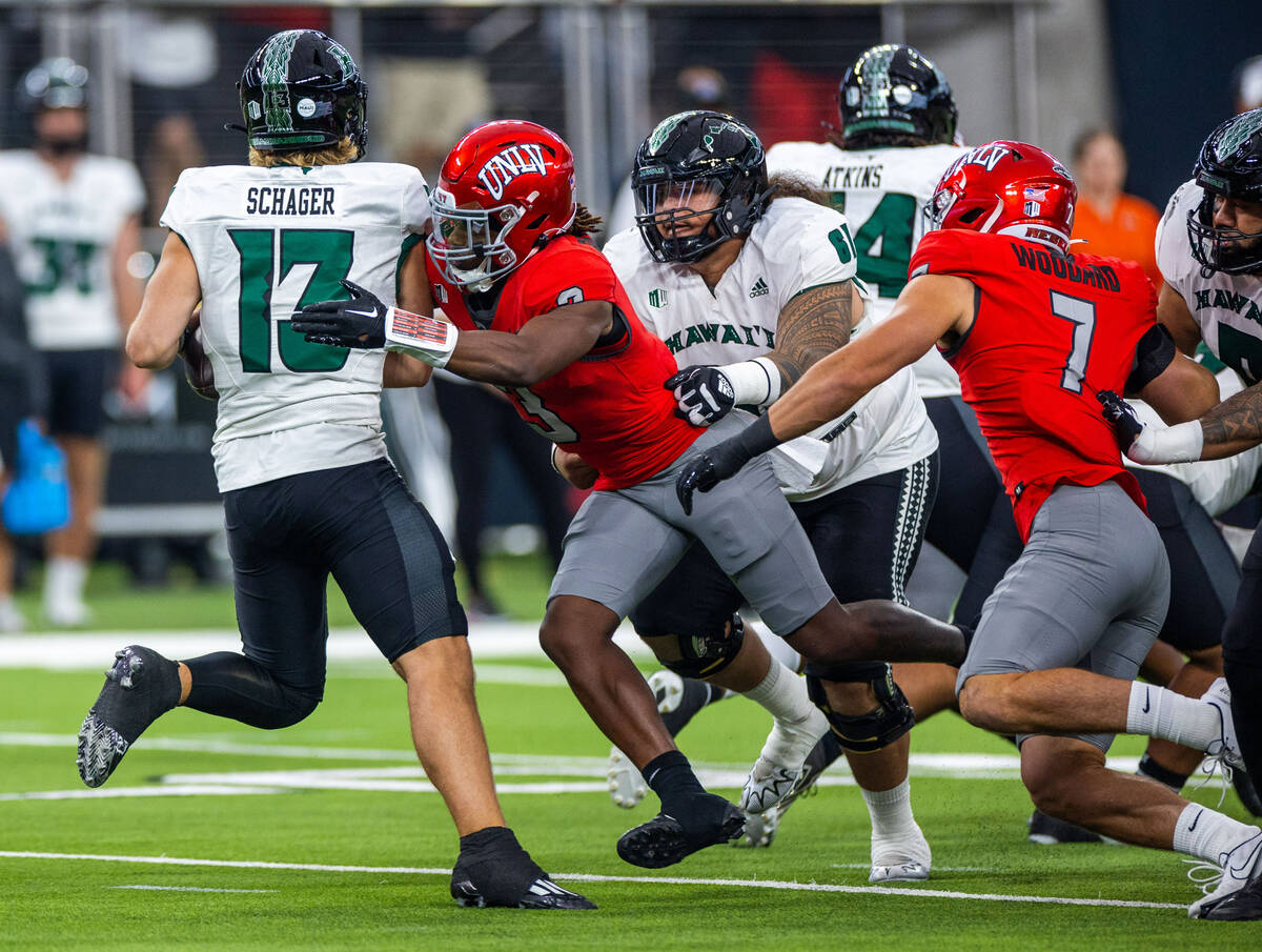UNLV defensive back Johnathan Baldwin (3) sacks Hawaii quarterback Brayden Schager (13) during ...