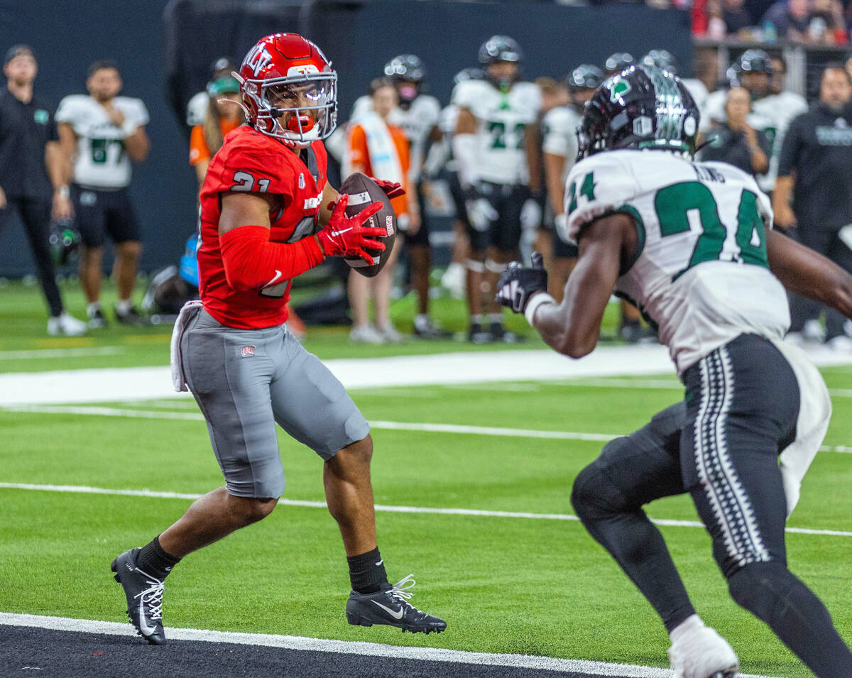 UNLV wide receiver Jacob De Jesus (21) catches a touchdown pass over Hawaii defensive back Devy ...