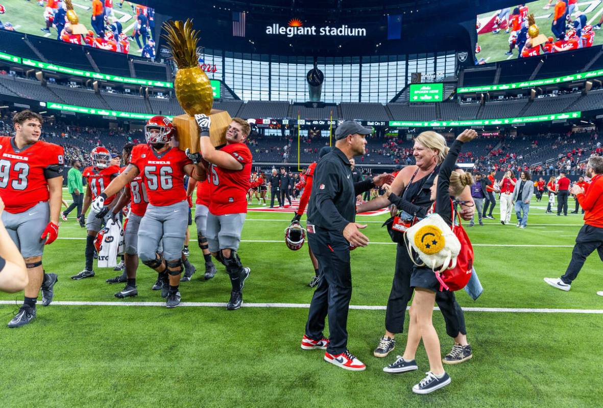 UNLV Head Coach Barry Odom greets his wife Tia and daughter Anna Lockwood Odom, 8, as players c ...
