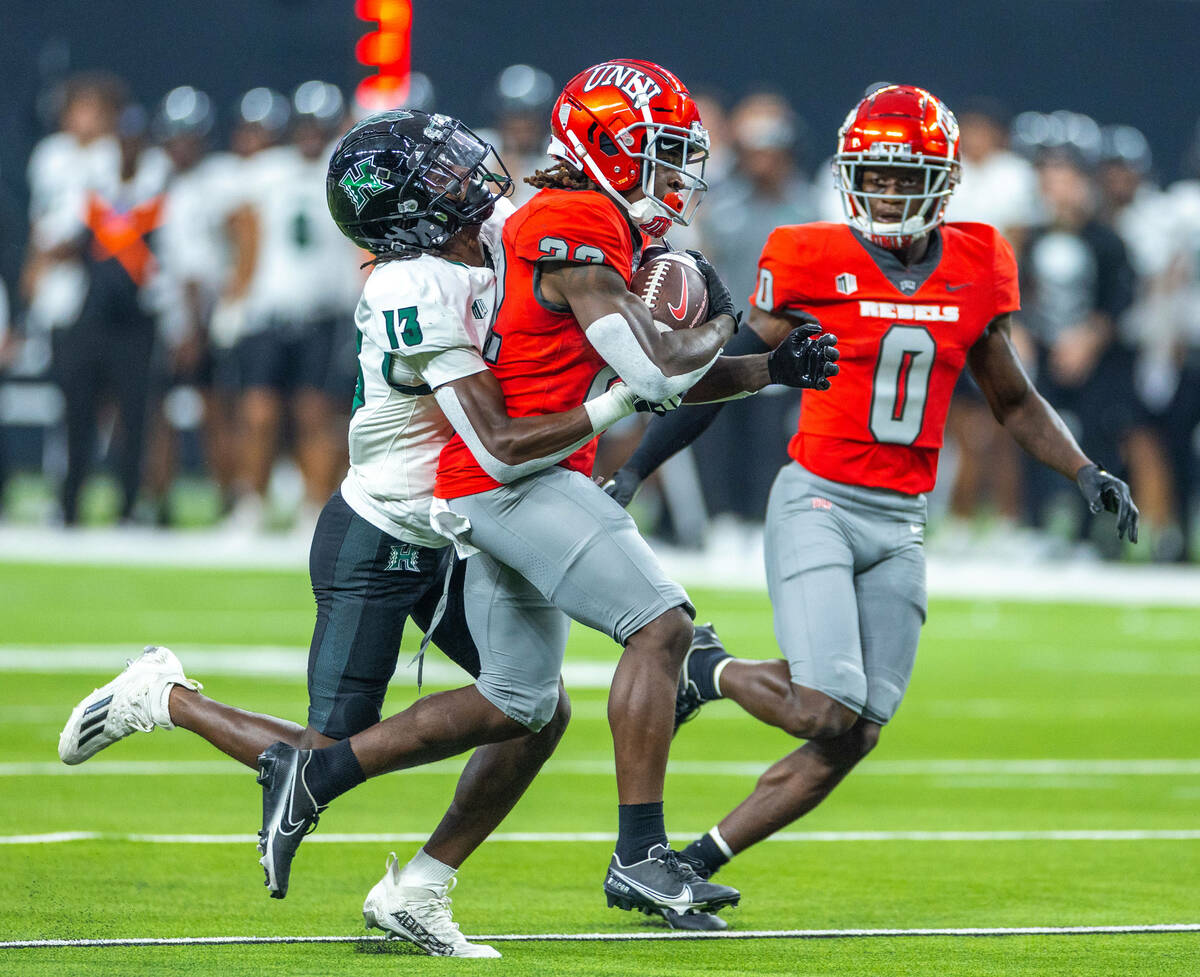 UNLV running back Jai'Den Thomas (22) is finally caught by Hawaii defensive back Caleb Brown (1 ...