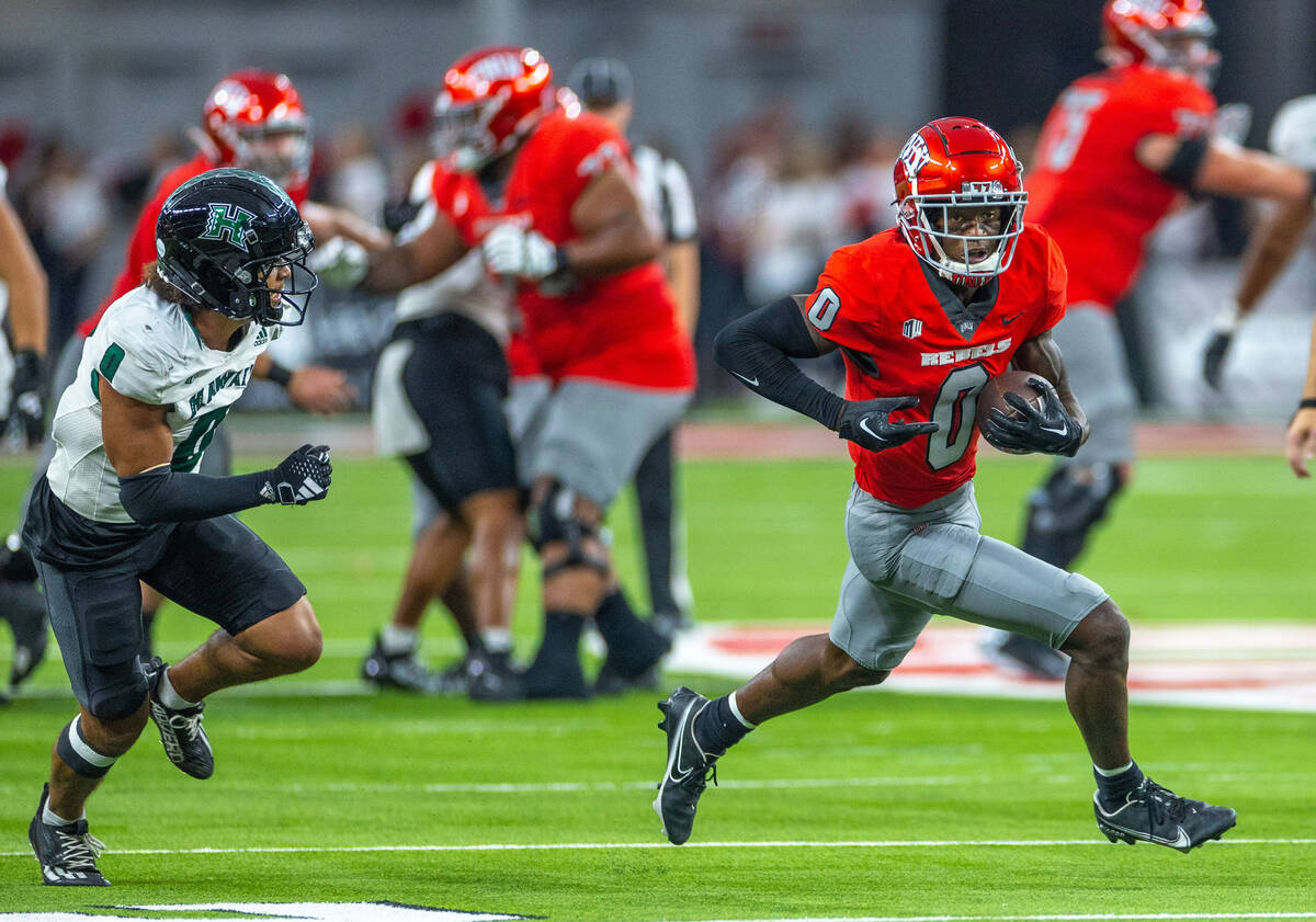 UNLV wide receiver Senika McKie (0) breaks free past Hawaii defensive back Cam Stone (0) during ...