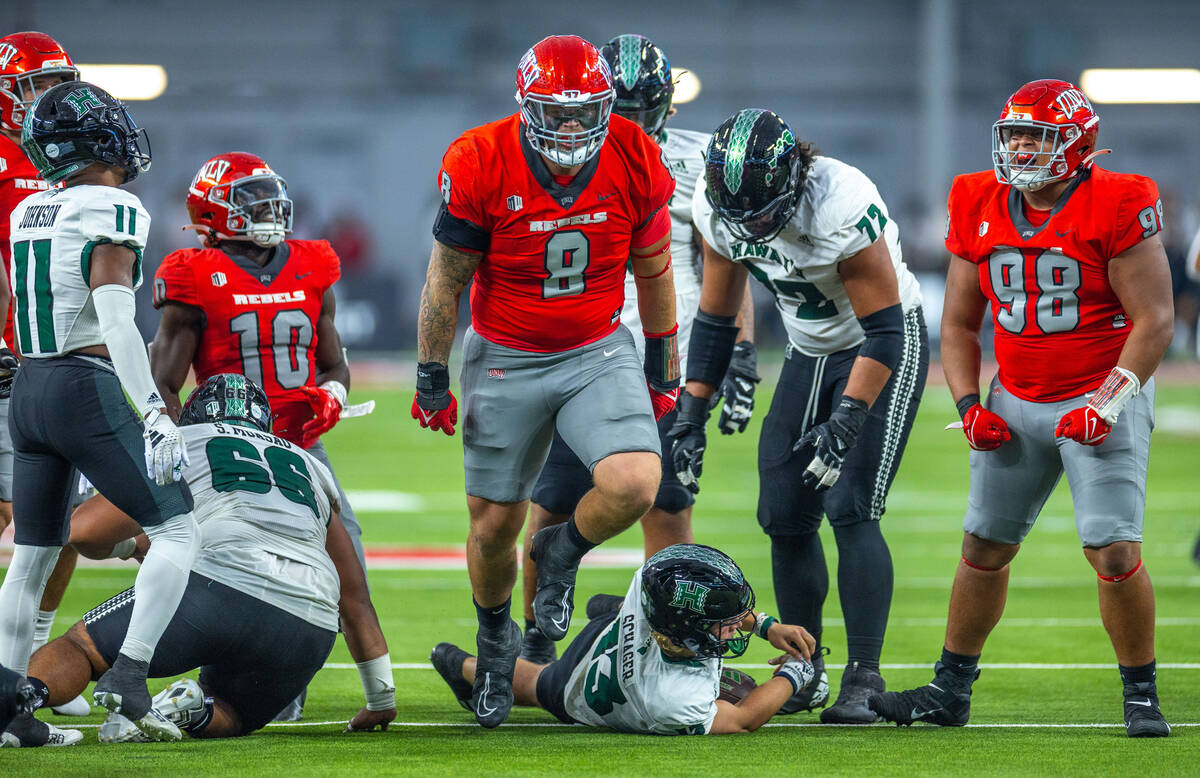 UNLV defensive lineman Darius Johnson (8) celebrates a sack on Hawaii quarterback Brayden Schag ...