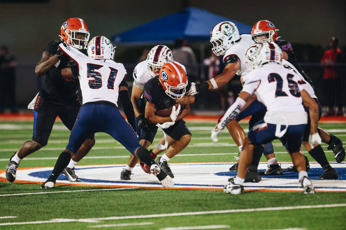 Bishop Gorman running back Myles Norman (24) makes his way through a pack of Liberty players wi ...