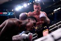 Canelo Alvarez, of Mexico, right, hits Jermell Charlo during their super middleweight title box ...