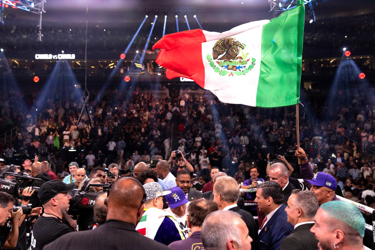 Canelo Alvarez, of Mexico, is surrounded after winning an undisputed world super middleweight t ...
