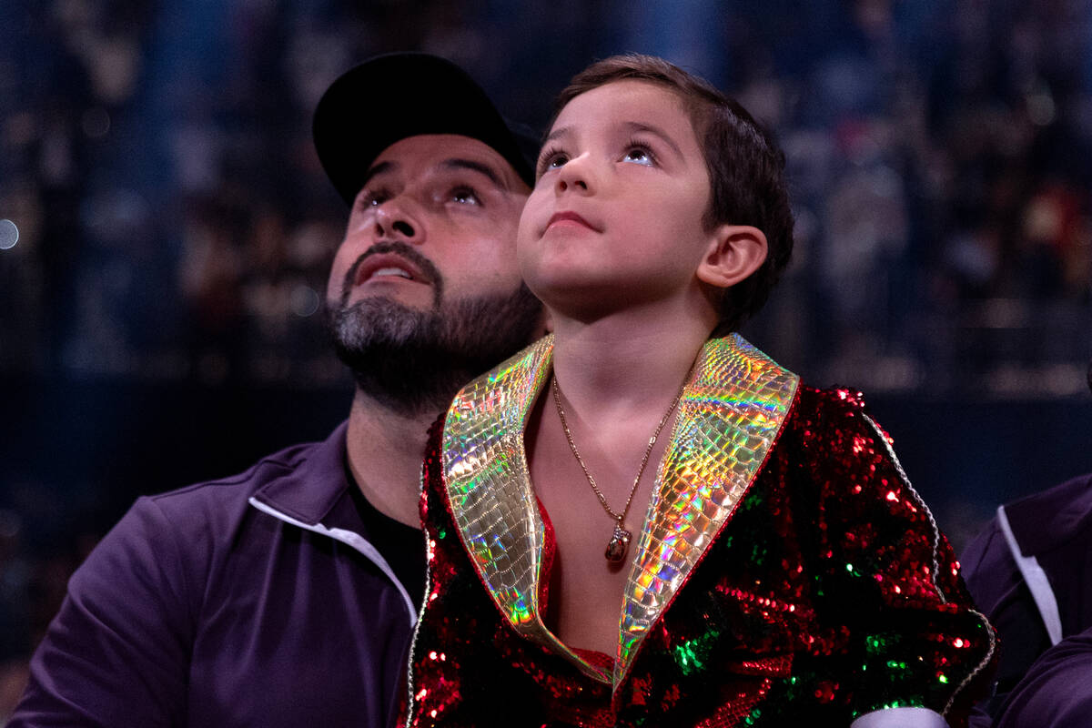 Canelo Alvarez’s son, Saul Adiel, looks up at his father on screen after Alvarez beat Je ...