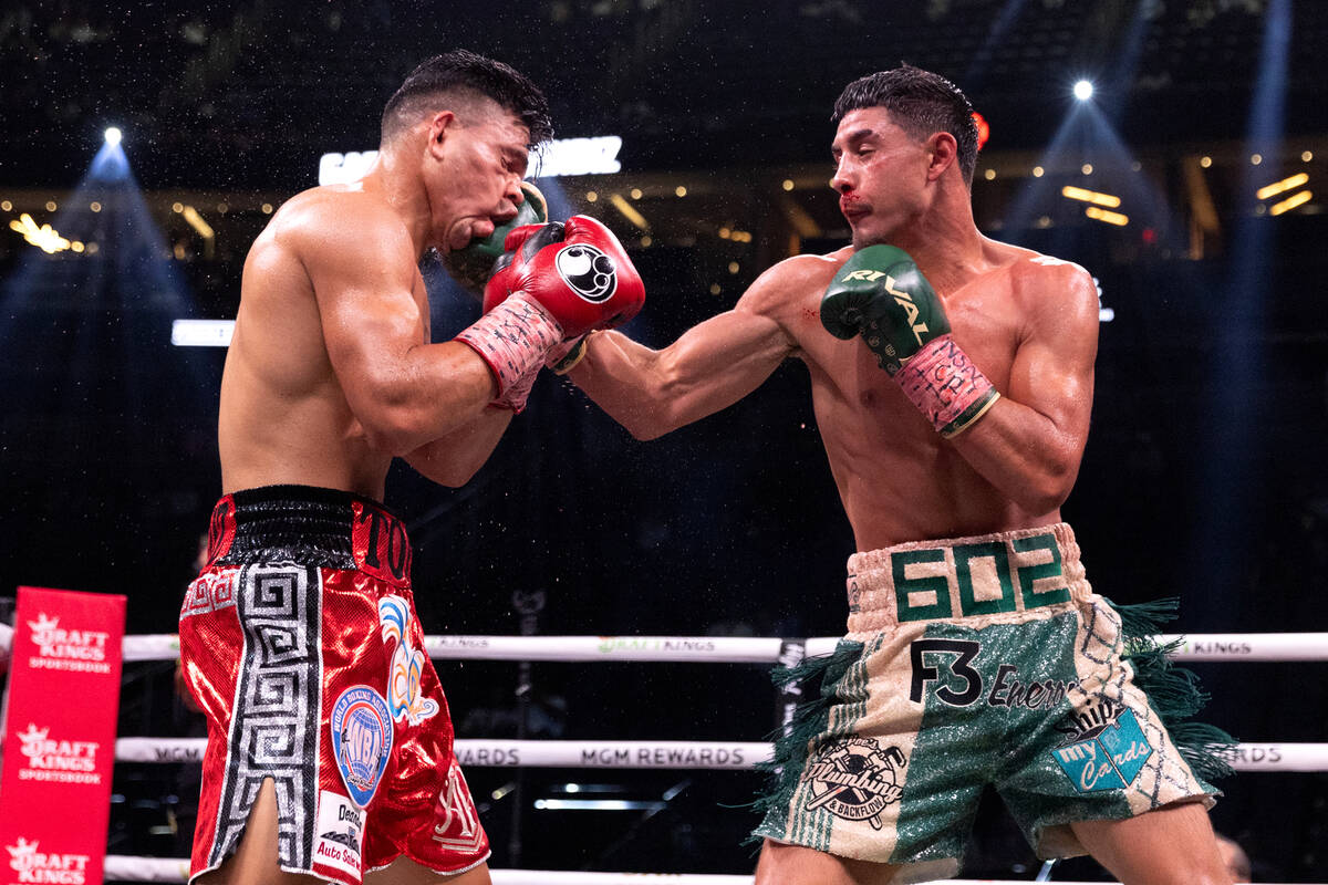Elijah Garcia, right, punches Armando Resendiz during a middleweight boxing bout at T-Mobile Ar ...