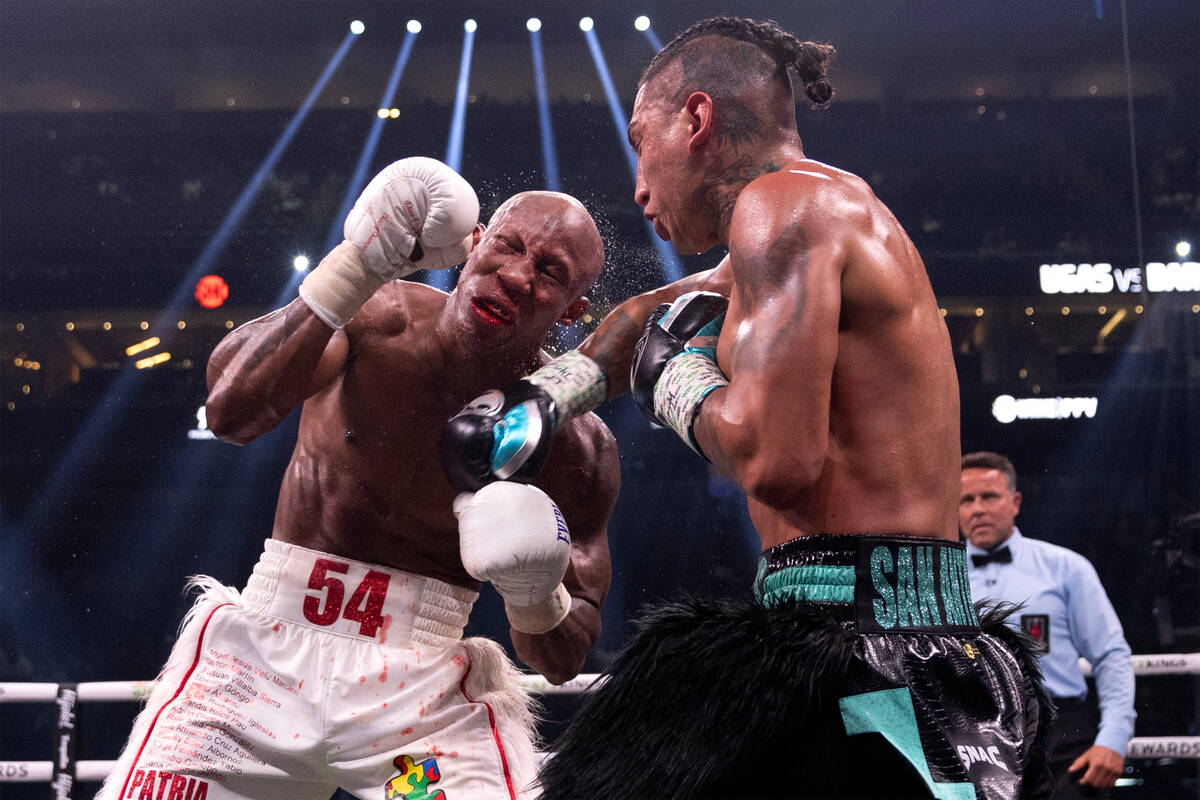Mario Barrios punches Yordenis Ugas during an interim WBC welterweight title boxing bout at T-M ...