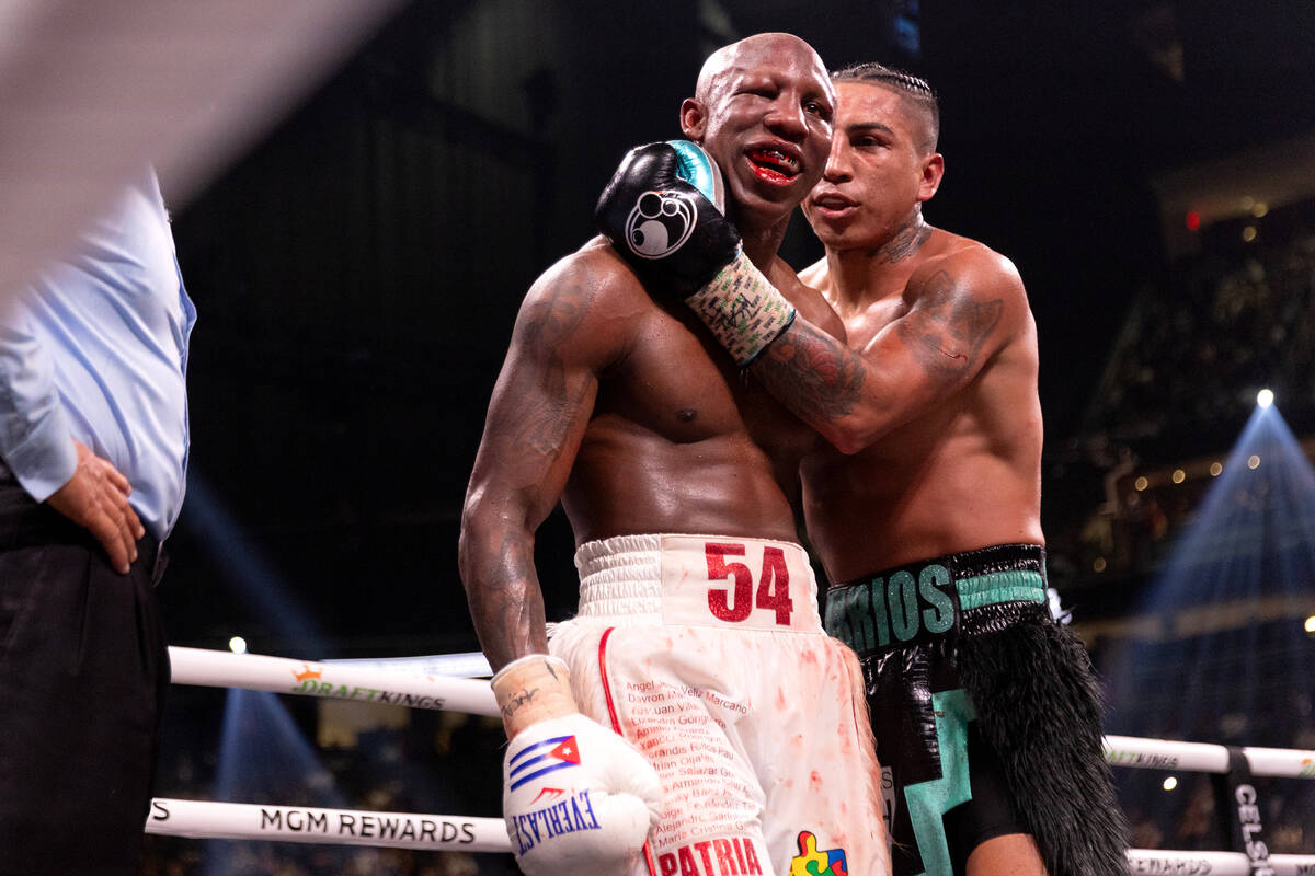 Mario Barrios congratulates Yordenis Ugas on a good fight during an interim WBC welterweight ti ...