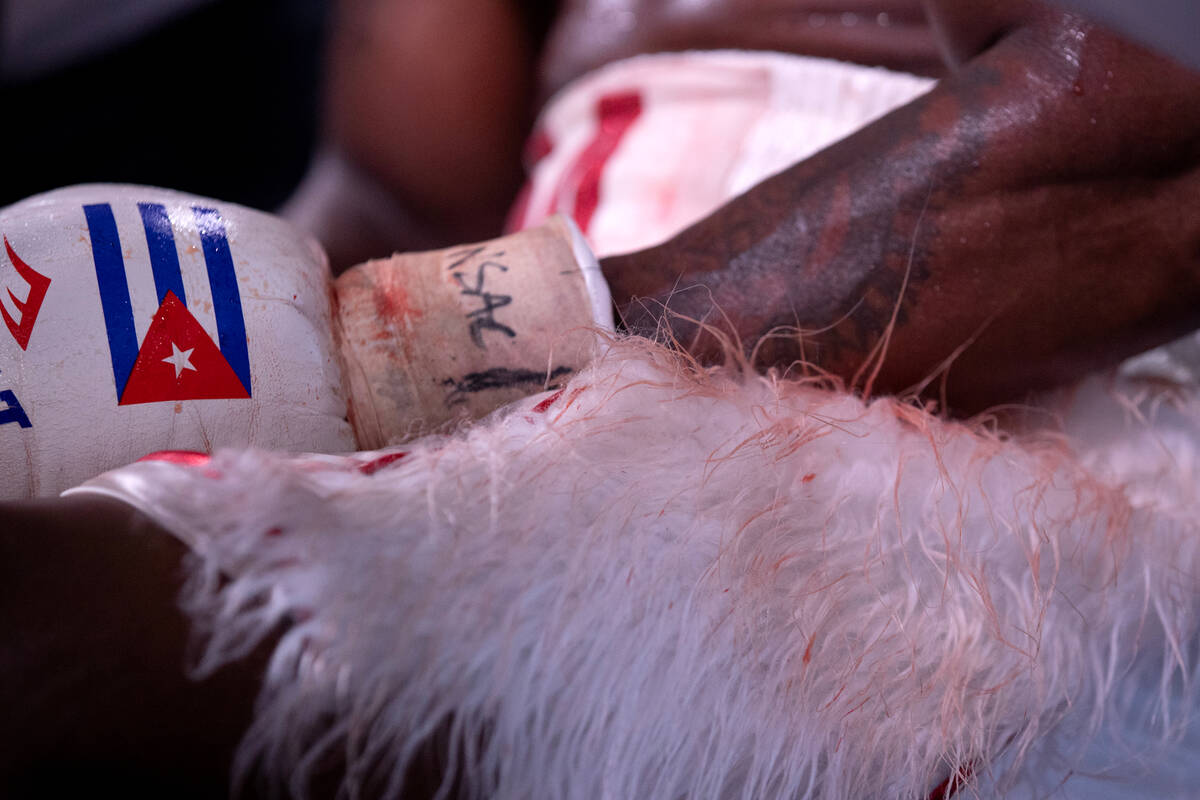 Yordenis Ugas’ clothing is tinged with blood during an interim WBC welterweight title bo ...
