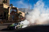 Kurt Busch performs a burnout during the NASCAR America Burnout Boulevard event on the Las Vega ...