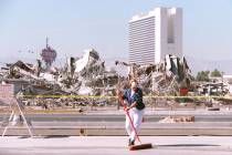 Adrea Davis, a Manpower employee, sweeps the parking lot at the Las Vegas Convention Center on ...