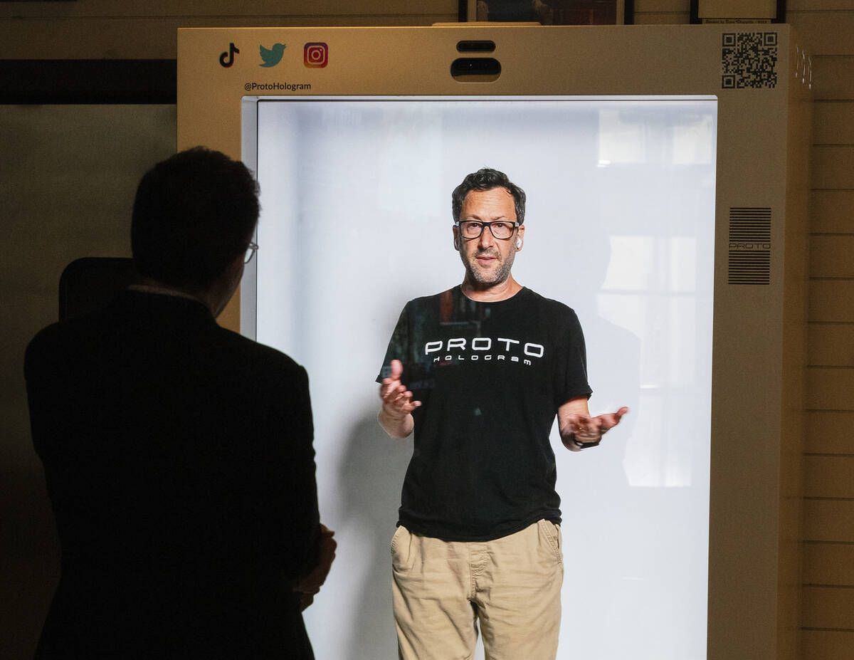 David Nussbaum, inventor and CEO of Proto Inc., speaks as he appears as a live hologram in a Pr ...